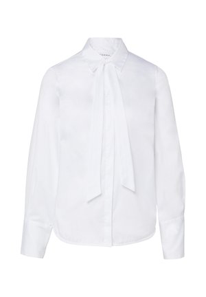 Blusa bianca a maniche lunghe con colletto appuntito e dettaglio frontale annodato, polsini con bottoni e orlo curvo.