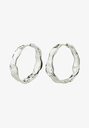 Silver hoop earrings feature a wavy, textured design. The metal has a polished finish with varying thickness along the edges.