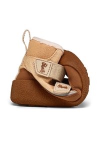 Botte de taille enfant avec une tige en textile beige, doublure en fausse fourrure douce et une semelle en caoutchouc marron texturée, dotée d'une sangle ajustable et d'un détail de marque.