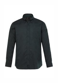 Camisa de manga larga de color verde oscuro con collar de botón, patrón texturizado sutil y un bolsillo en el pecho. Presenta botones azul marino y un corte estructurado.