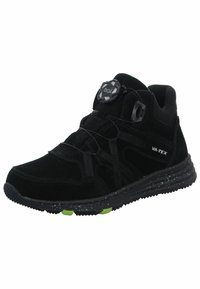 Zapatilla deportiva negra con parte superior de ante, superposiciones texturizadas, sistema de cordones BOA y suela negra moteada. Acentos verdes en la suela.
