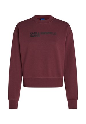 Bordový svetr s kulatým výstřihem, dlouhými rukávy a zkráceným střihem. Na přední straně se nachází černé logo "KARL LAGERFELD JEANS". Měkká textura.