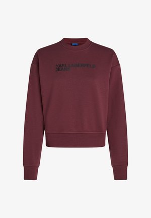 Sweatshirt vinho com gola redonda, mangas longas e design cropped. Apresenta o logo preto "KARL LAGERFELD JEANS" na frente. Textura suave.