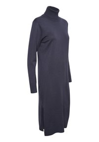 Laivaston sininen kaulustunika, joka on valmistettu pehmeästä neulotusta kankaasta. Siinä on pitkät hihat, sivurei'itys ja rento istuvuus. Sileä pinta, minimalistinen muotoilu.