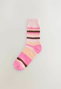 Multicolored sock with a ribbed cuff. Features pink, beige, and brown stripes in varying widths and textures. Soft knit material.