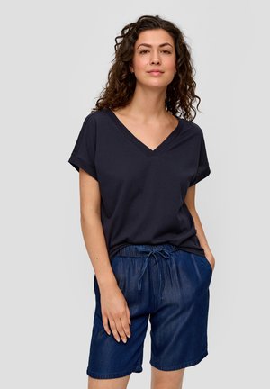 T-shirt en coton bleu marine avec un col en V et des manches courtes repliées, associé à un short en denim foncé avec une taille élastique et un cordon de serrage.