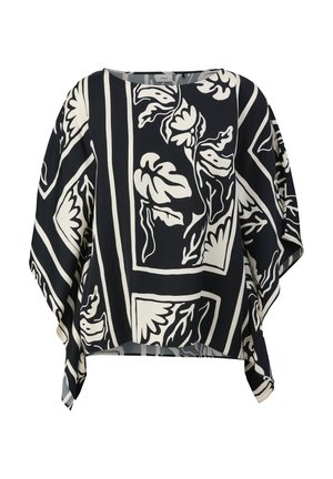 Blouse à imprimé floral en noir et blanc, avec une coupe boxy, des manches larges et un col rond, offrant une coupe décontractée.