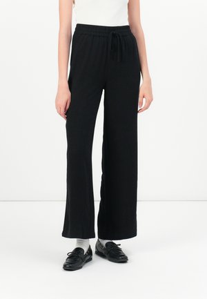Black wide-leg pants with an elastic waistband and drawstring. Made of soft fabric, featuring a relaxed fit and minimal stitching details.