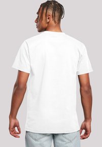 White cotton t-shirt with a crew neck, short sleeves, and a plain back. Features a relaxed fit and smooth fabric texture.