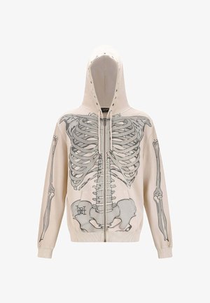 Beige hoodie met een skeleton graphic, voorrits, een capuchon met trekkoorden en twee voorzakken. Gemaakt van zacht materiaal met een relaxte pasvorm.