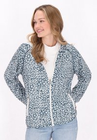 Leopardmönstrad jacka i teal och vitt, med dragkedja fram, sidofickor och textil med struktur. Har en avslappnad passform och långa ärmar.