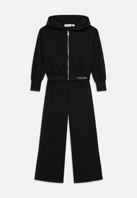 Mono con capucha negro, de manga larga y con cremallera frontal. Presenta una cintura ajustada con el logo de Calvin Klein, fabricado en un tejido suave.