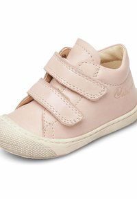 Pink leather shoe with two Velcro straps, rounded toe, textured rubber sole, and stitched detailing. Features logo on the side.