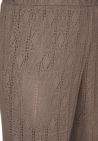 Brune strikkede leggings med diamantmønster og hulmønster, ribbet talje og let stof til åndbarhed.