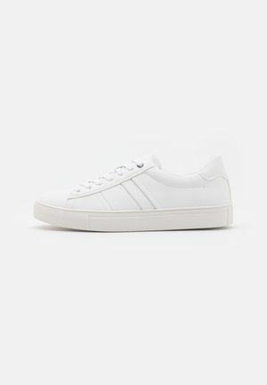 White leather sneaker with a round toe, contrasting side stripes, lace-up front, and textured rubber sole. Smooth finish throughout.