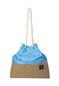 Blue and brown tote bag with repeated "RELAXED" text, featuring thick white rope handles and a small black patch with logo.