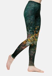 Leggings z temno zeleno podlago z cvetličnim vzorcem v živahnih barvah, ki prikazuje teksture in vzorce različnih cvetlic.