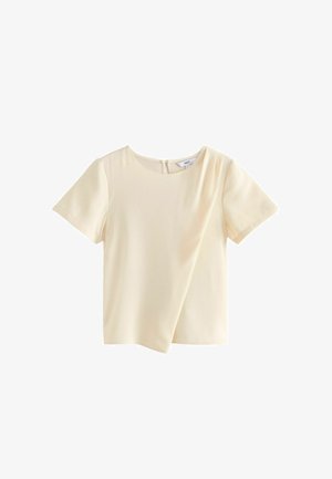 Krémový top s krátkymi rukávmi a okrúhlym výstrihom s diagonálnym pruhovým dizajnom. Obsahuje zips na chrbte a hladký, jemný materiál.