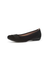 Bailarinas negras hechas de un tejido suave, con punta redondeada y un acento decorativo de tachuelas en la parte delantera. Suela baja y flexible.