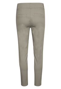 Pantalons beige slim-fit avec une texture lisse, deux poches arrière et une taille propre, présentant un design de jambe fuselée et un minimum de détails.