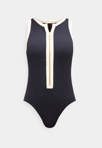 Αμάνικο μαύρο κορμάκι με λευκή επένδυση και χρυσό φερμουάρ μπροστά με κυκλικό έλξη, υφή υφάσματος με ρίγες.