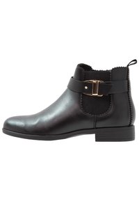 Black leather ankle boot with elastic side panels, gold-tone buckle accent, rounded toe, and a low block heel. Smooth texture.