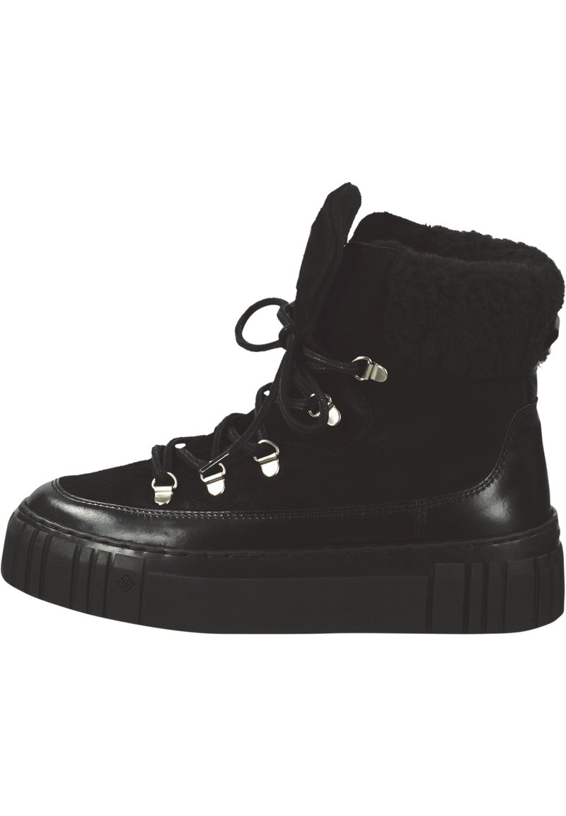 Schwarze Knöchelstiefel aus Wildleder und Leder, mit strukturiertem Fellbesatz, silberner Schnürhardware und schwerer schwarzer Gummisohle.