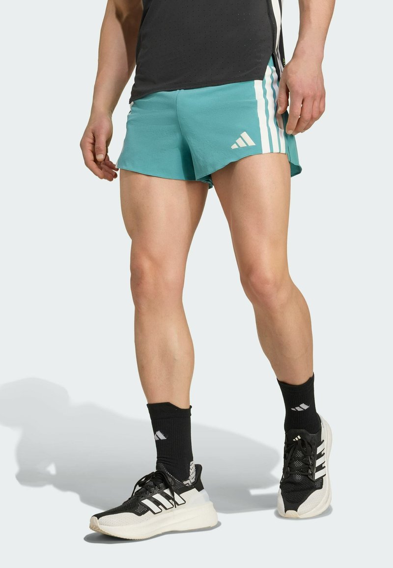 Turquoise athletic shorts with three white stripes, paired with black socks and sneakers. The shorts have a lightweight, textured fabric.