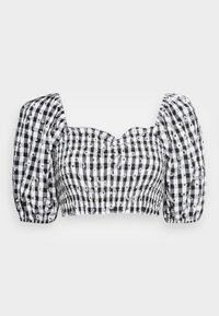 Top cropped de manga bufante em padrão xadrez preto e branco. Apresenta detalhe de smocking, um decote coração e acentos florais por todo o tecido.