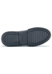 Semelle de chaussure en caoutchouc noir avec des rainures horizontales et verticales pour l'adhérence, arborant le nom de marque en relief "Gabor" au centre.