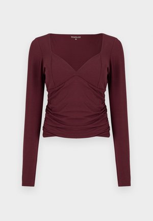 Haut bordeaux à manches longues avec un décolleté carré, des côtés froncés et une coupe moulante en tissu doux et extensible.