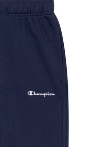 Navyblauwe trainingsbroek van zachte katoenmixstof, met een elastische tailleband en een geborduurd wit "Champion"-logo.