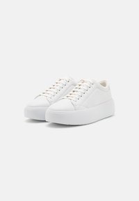White sneakers with a smooth leather upper, rounded toe, and a thick platform sole. Features tonal laces and a minimalist design.