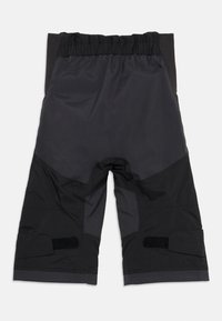 Svarte vanntette shorts med elastisk midje, med distinkte tone-i-tone paneler, borrelåsdetaljer og en teksturert finish.