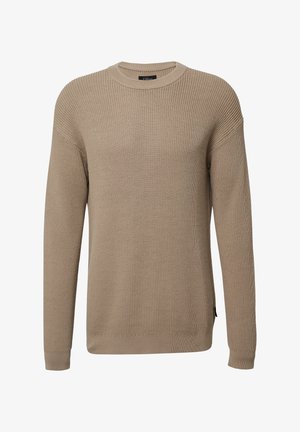 Pull en tricot beige avec un col rond, texture côtelée et manches longues. Présente une coupe légèrement décontractée et des fentes sur les côtés à l'ourlet.