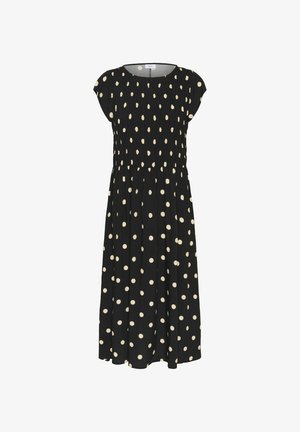 Zwarte jurk met crèmekleurige polka dots, met een ingesmeerd lijfje, kapmouwen en een vloeiende rok. Gemaakt van lichtgewicht stof.