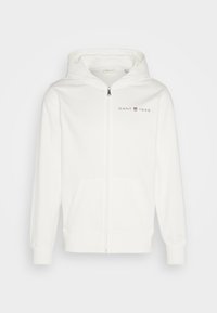 Sweat à capuche blanc zippé avec poches avant, capuche, et logo "GANT 1949" sur la poitrine gauche.