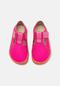 Φωτεινά ροζ καμβά παπούτσια με λουράκι βέλκρο, ανοιχτές πλευρές και καφέ καουτσούκ σόλα με λεπτομέρειες ραφής. Ελαφρύς και αναπνεύσιμος σχεδιασμός.