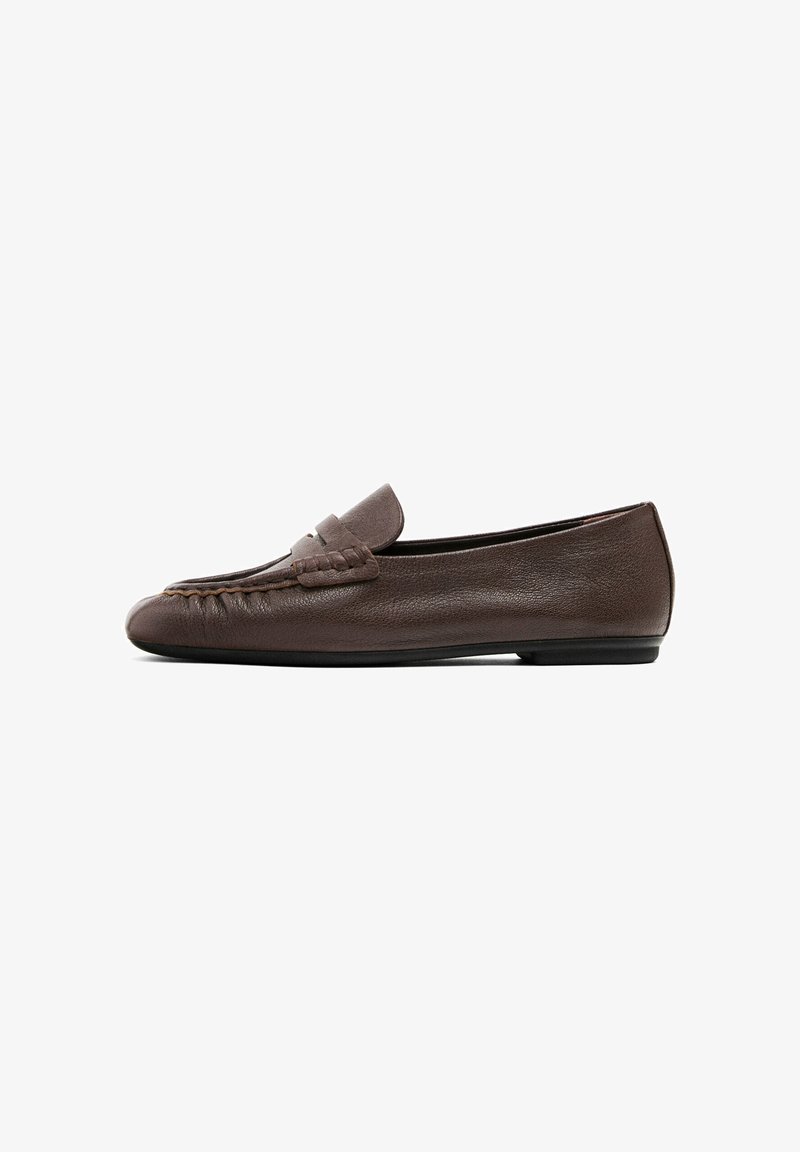 Brown leather moccasin-style flat shoe with a stitched accent on the upper and a smooth texture. Low-profile design with a flexible sole.