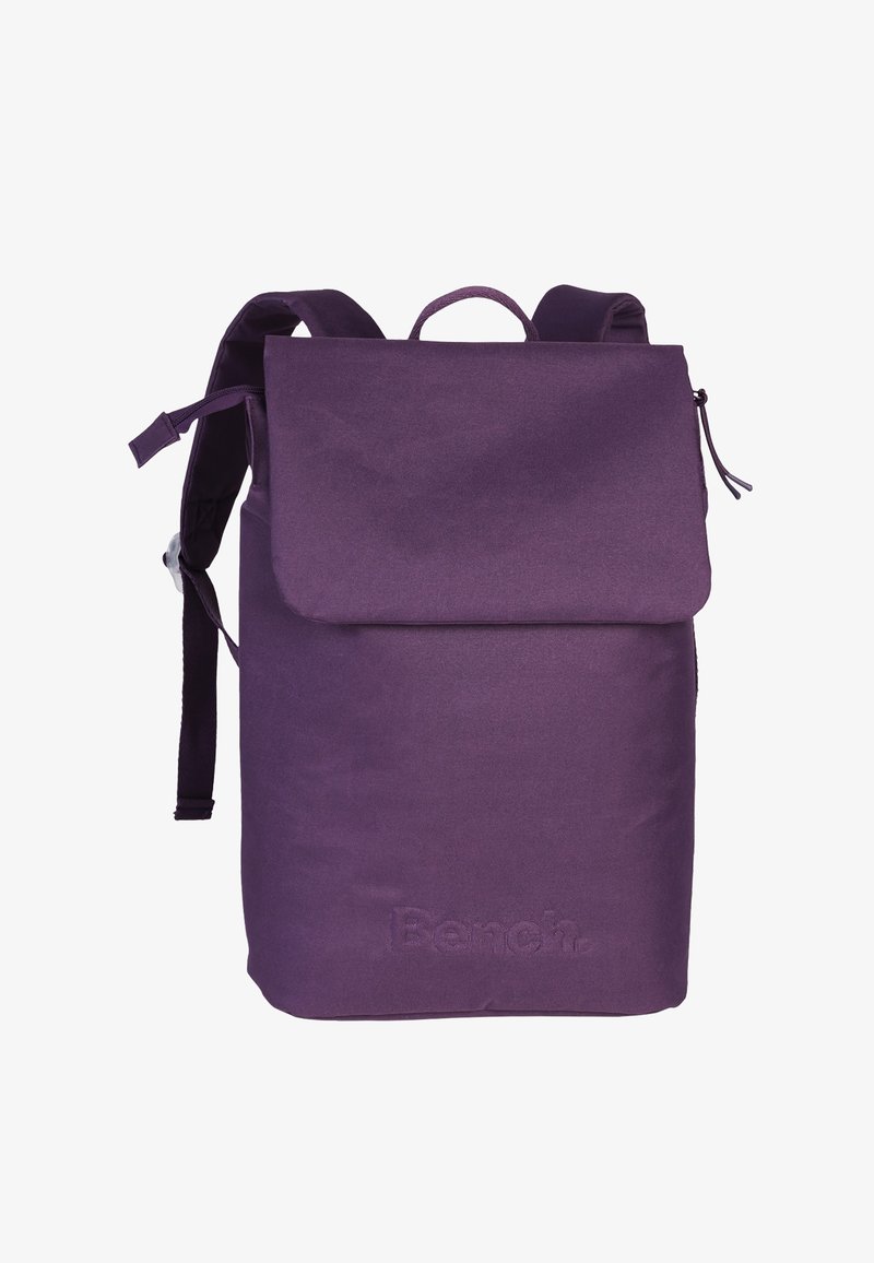 Purple fabric backpack with a flap closure, adjustable straps, and a small top handle. Features embossed brand logo on the front.