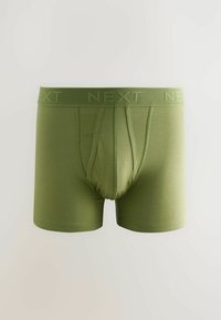 Groene boxers van zacht materiaal, met een elastische band waarin het logo "NEXT" is verwerkt. Strakke pasvorm met een gevormde pouch voor comfort.