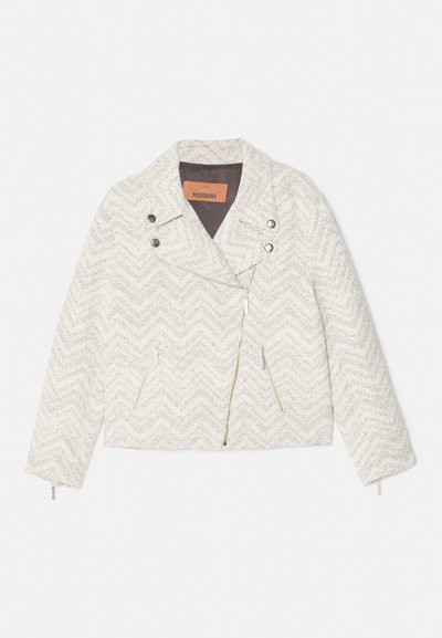 White chevron-patterned jacket made of textured fabric. Features a notched collar, front zip, and two zippered pockets. Silver hardware accents.