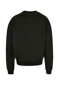 Felpa nera con colletto e polsini a costine. Caratterizzata da una vestibilità rilassata e da una consistenza morbida. Design semplice senza motivi o accessori.