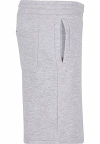Lys grå treningsshorts med elastisk midje og to sidelommer. Laget av et mykt, teksturert stoff med en avslappet design.
