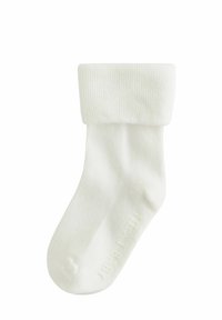 Calzino bianco a coste con cinturino pieghevole, realizzato in materiale morbido. Presenta una texture liscia e un design a punta arrotondata.