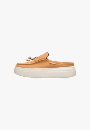 Scarpa marrone chiaro senza lacci con suola bianca spessa e lacci decorativi sopra, vista laterale su sfondo bianco.