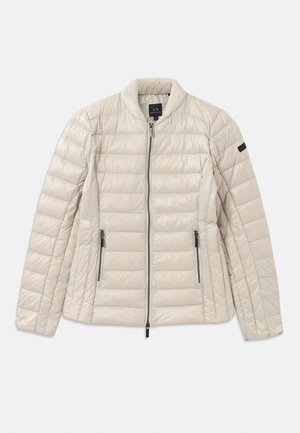 Beige puffer-takki vetoketjulla edessä, sivutaskuilla ja pystykauluksella. Sisältää tikkikankaan ja tyylikkään, minimalistisen muotoilun.