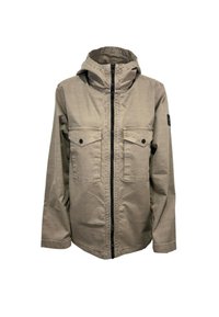 Giacca beige chiaro con cappuccio, due tasche sul petto, zip nera e tessuto leggermente testurizzato. Presenta una toppa nera con logo sulla manica.