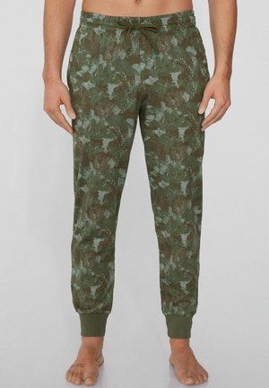 Grüne Camo-Jogginghosen mit elastischem Bund und Kordelzug, aus weichem Baumwollmaterial mit schmal zulaufenden Beinabschlüssen. Auffälliges strukturiertes Muster.