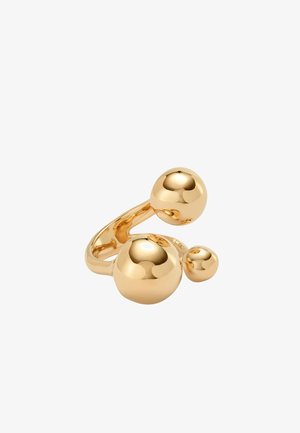 Bague réglable en ton or avec trois sphères lisses et polies de tailles variées reliées par un anneau incurvé.